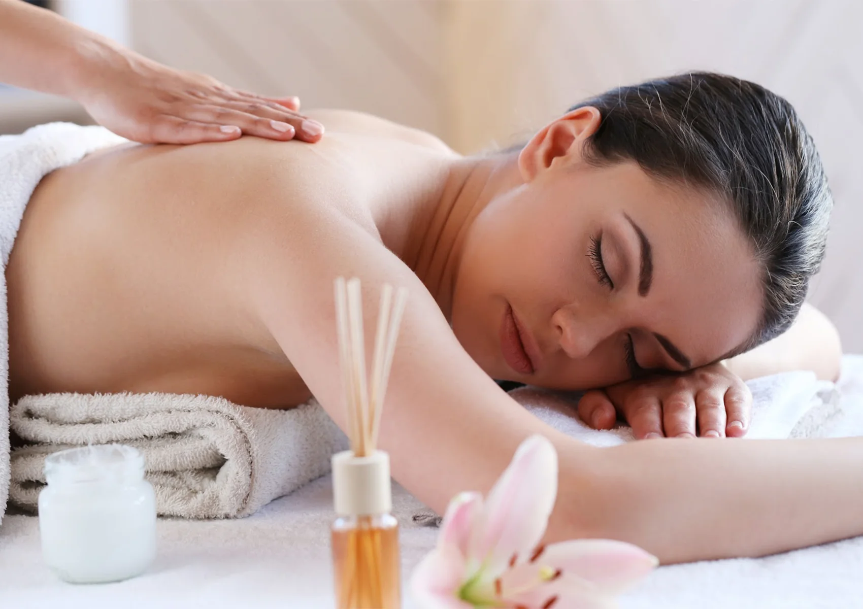 A woman enjoying a relaxing Balinese massage treatment at a wellness spa in Ubud, Bali.