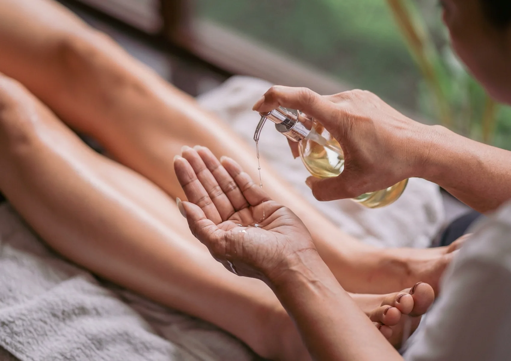 Relaxing foot massage oil treatment in Ubud with aromatic massage oil and soothing foot therapy for stress relief and muscle relaxation in a Bali spa environment